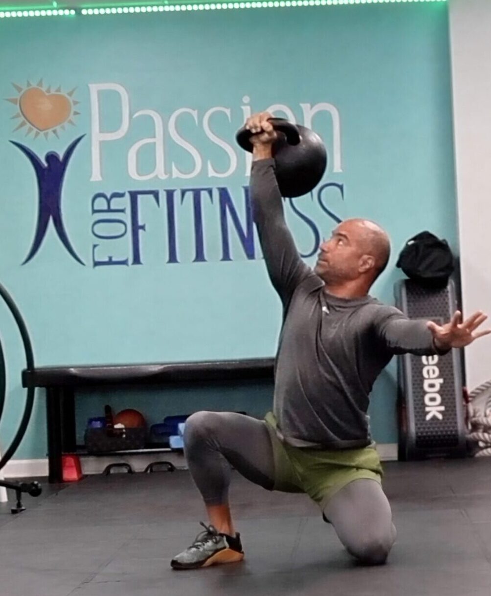 Personal trainer in Phoenixville PA coaching a Turkish get up at Passion for Fitness