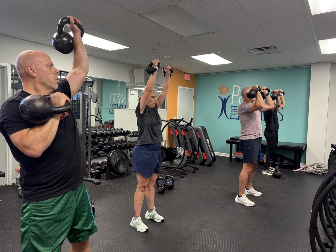 Group kettlebell training class for adults at Passion for Fitness Exton PA